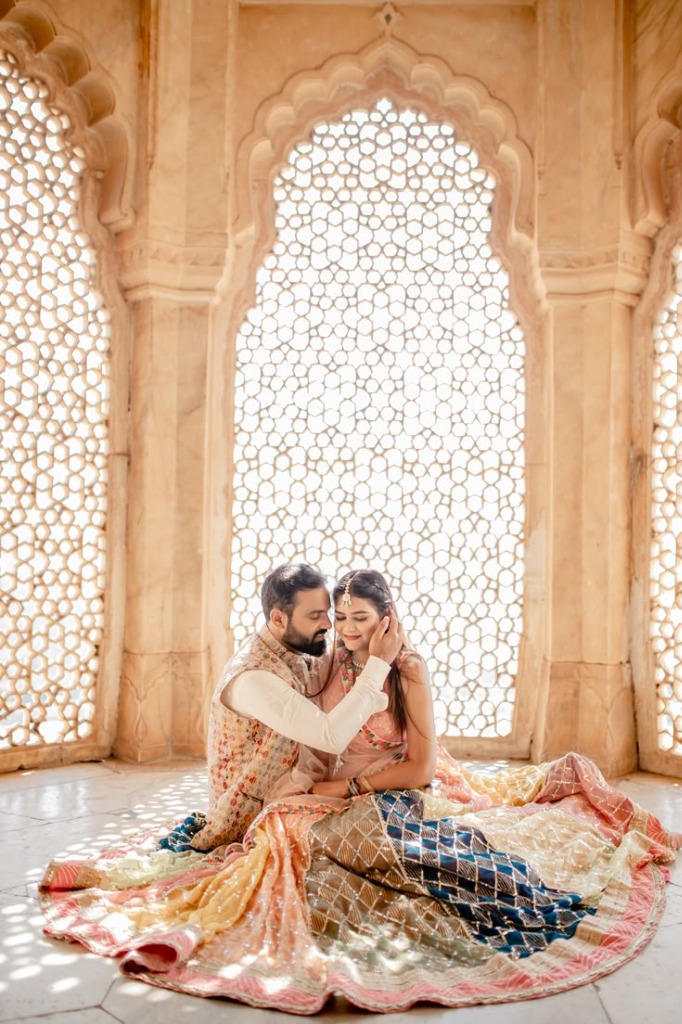 Rohan and Meera intimate moment sitting in front of a carved palace window